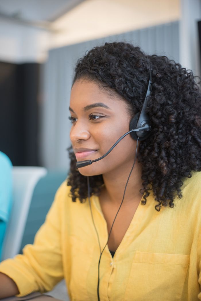 Close-up of a customer service agent wearing a headset