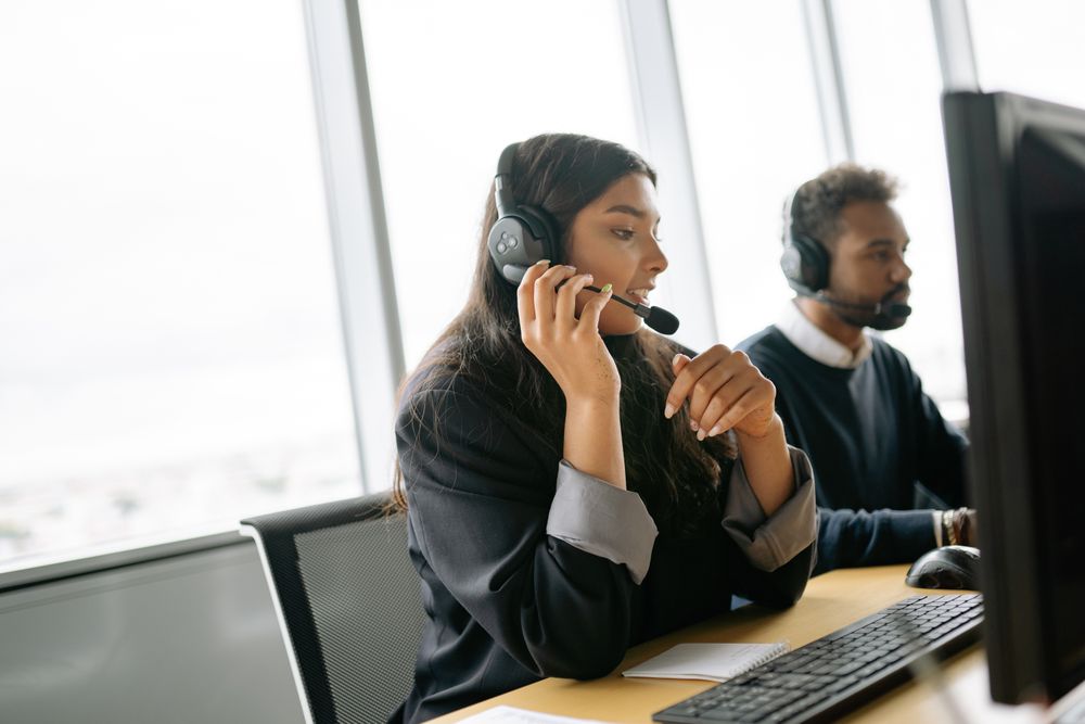 Call center agents on headsets working at their desks
